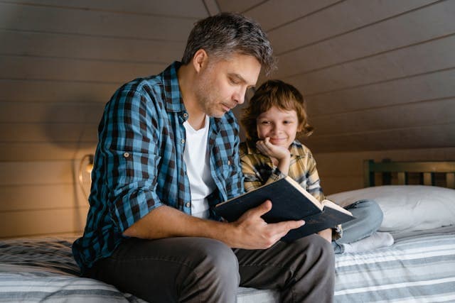 A parent reading with a child, representing stories shared across generations